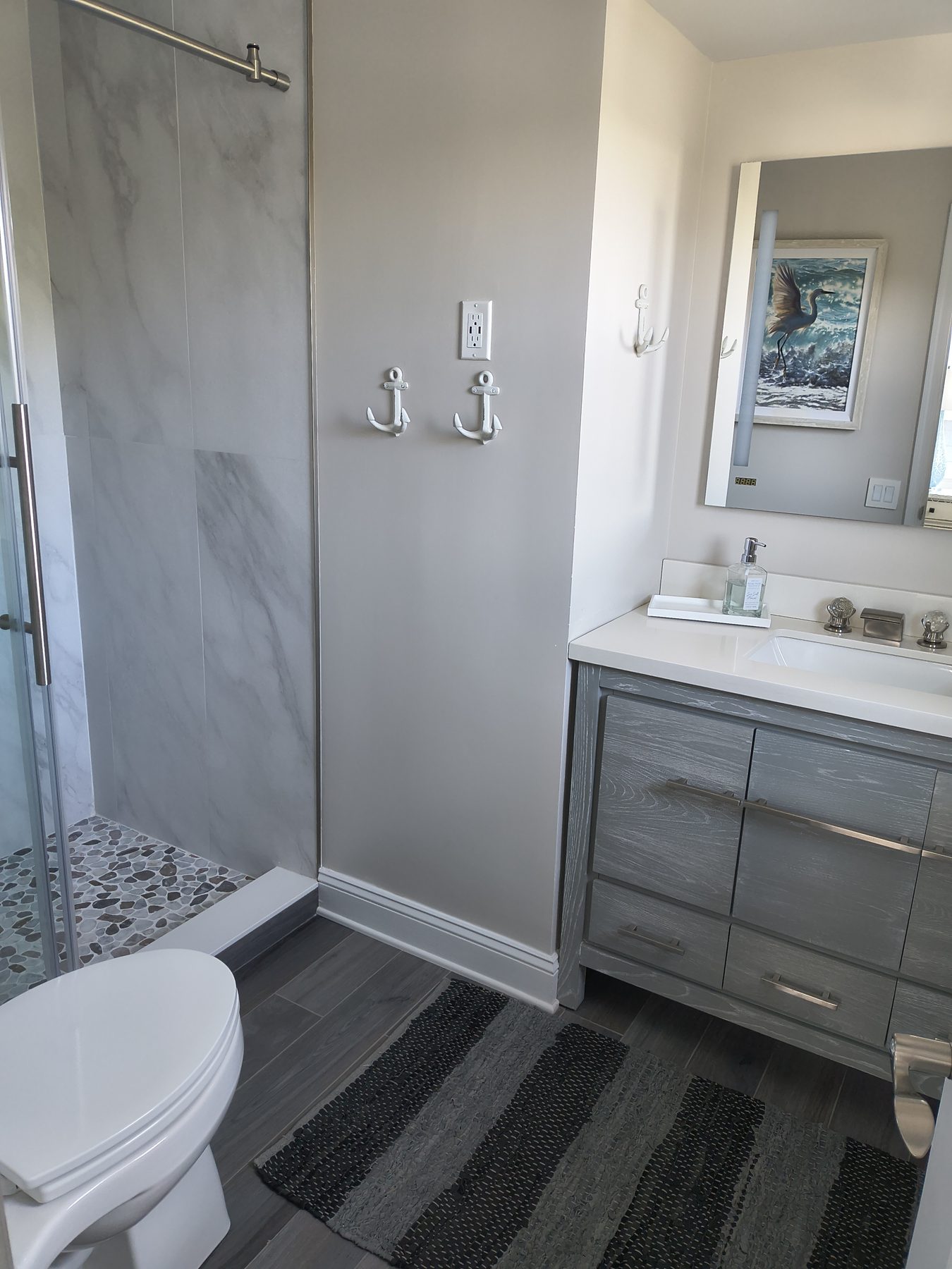 Bathroom with anchor hooks and marble shower