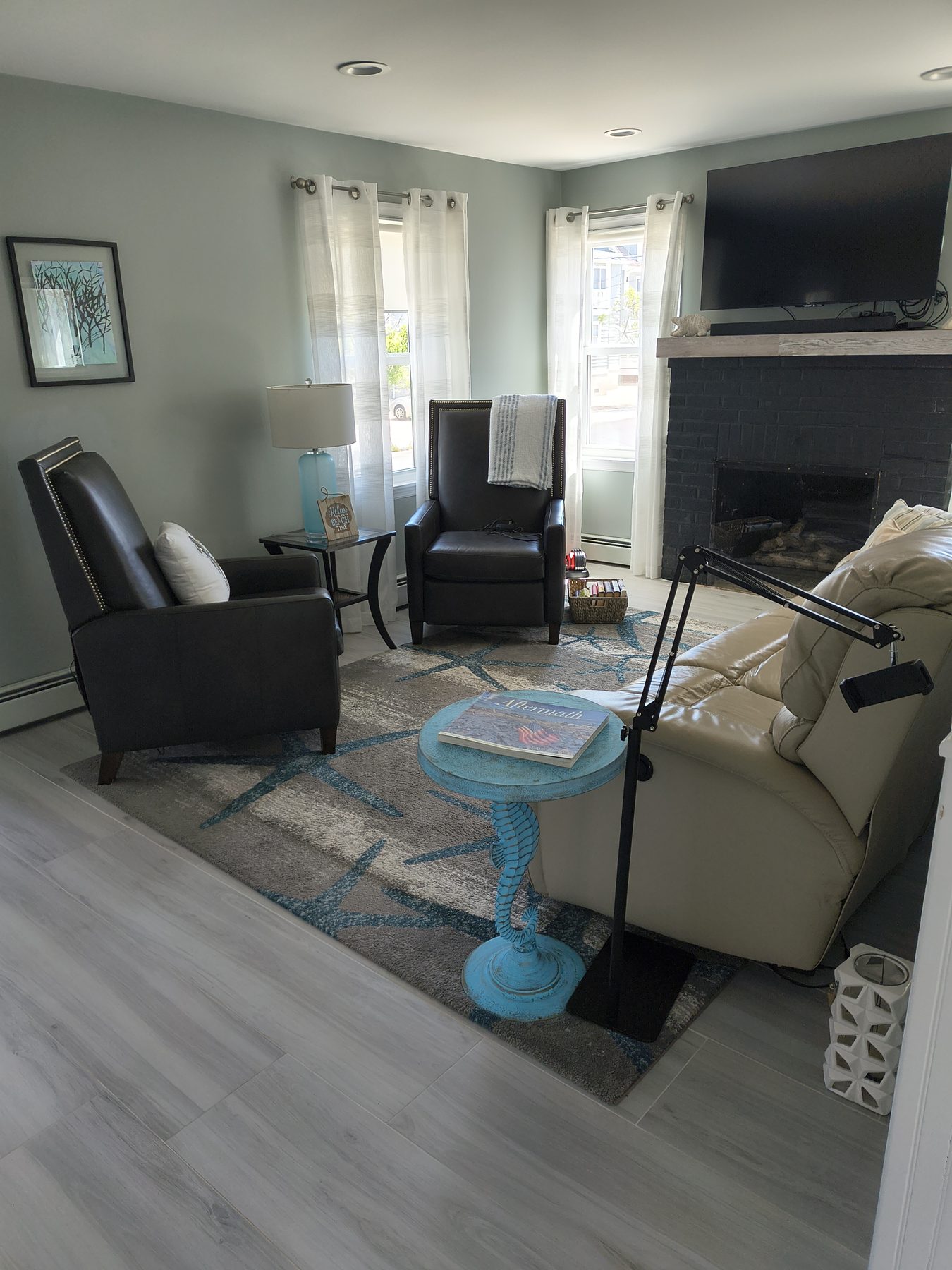 Sitting room with leather chairs and fireplace