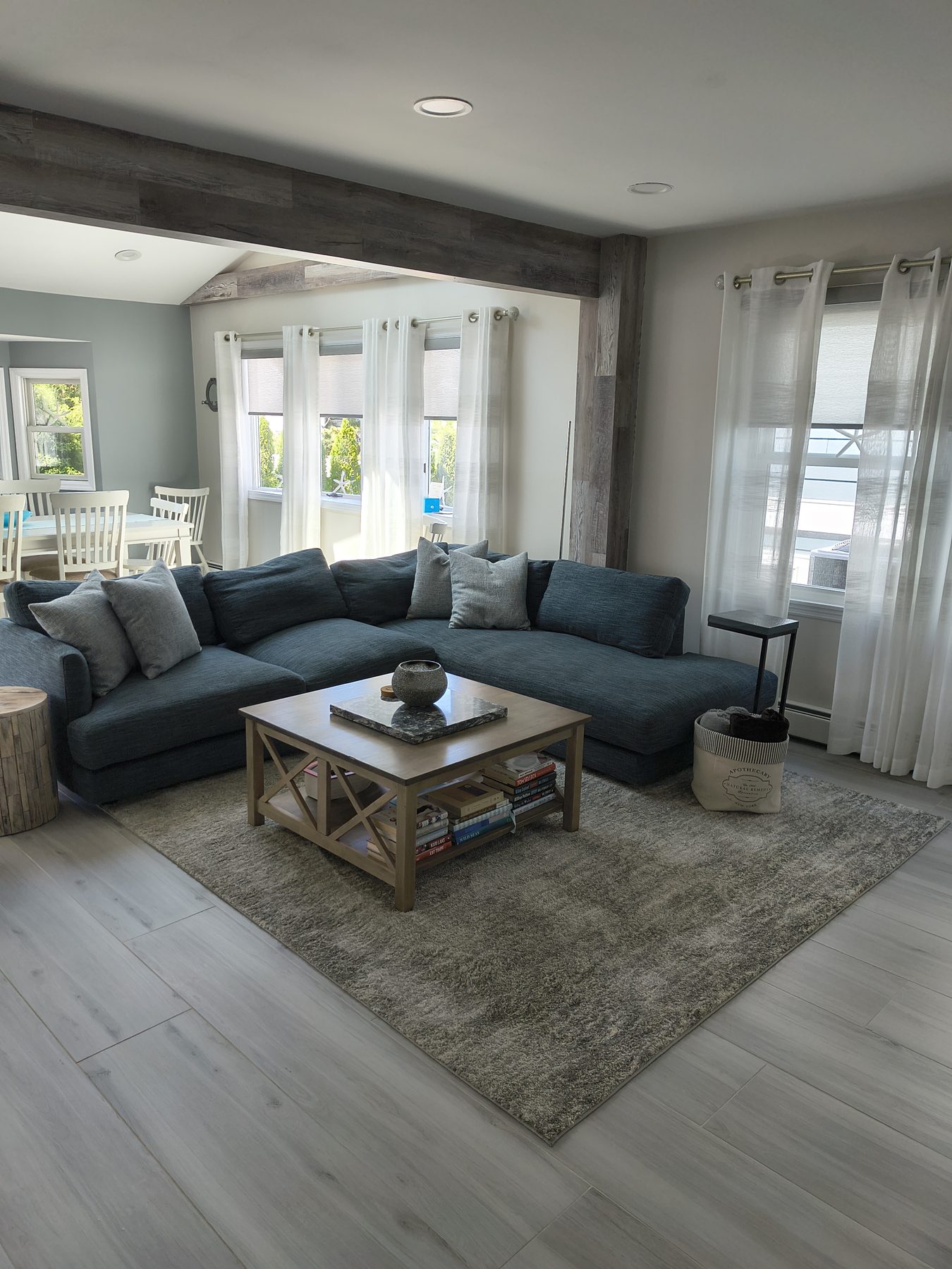 Family den with blue sectional and coffee table