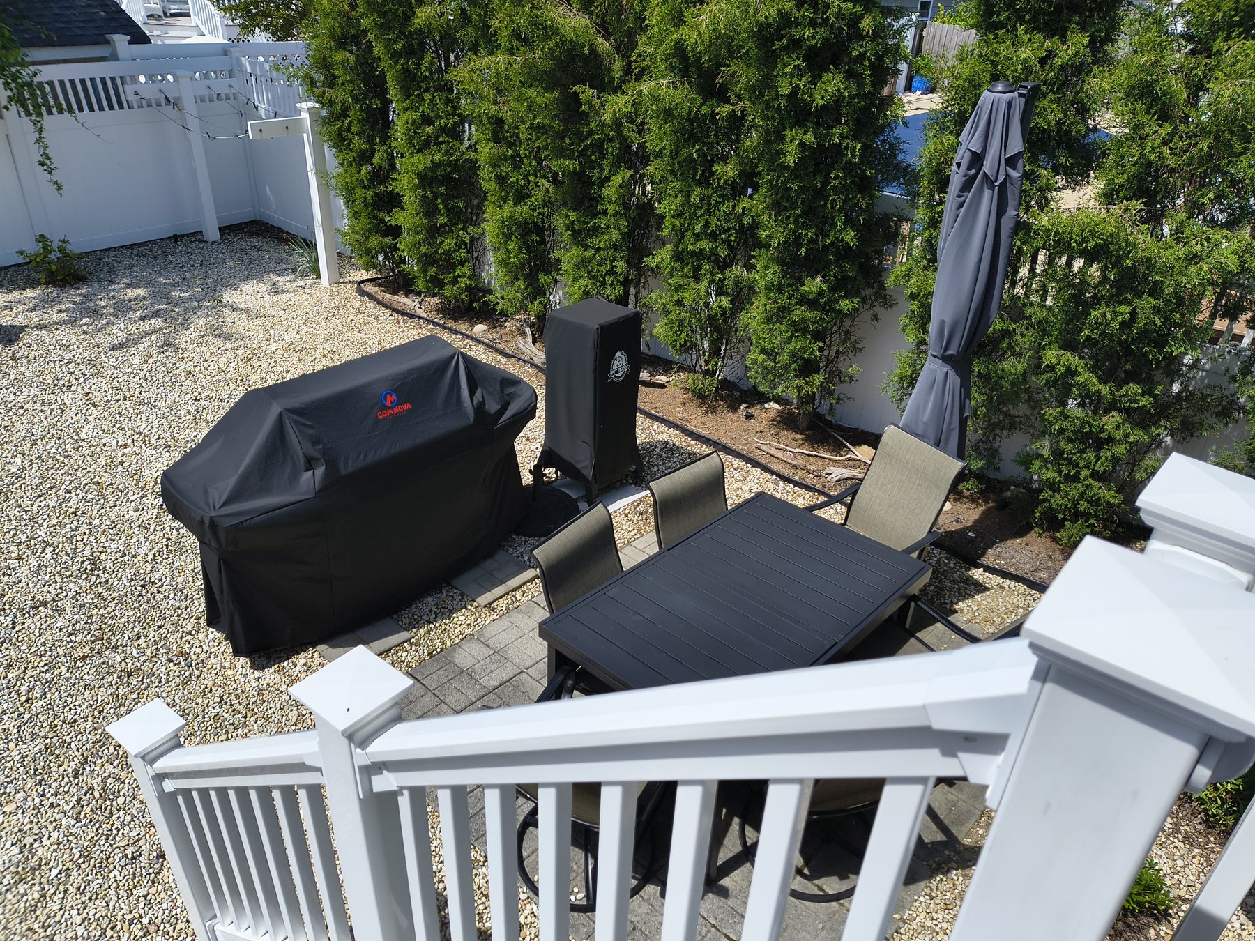 Outdoor patio table with chairs and grill