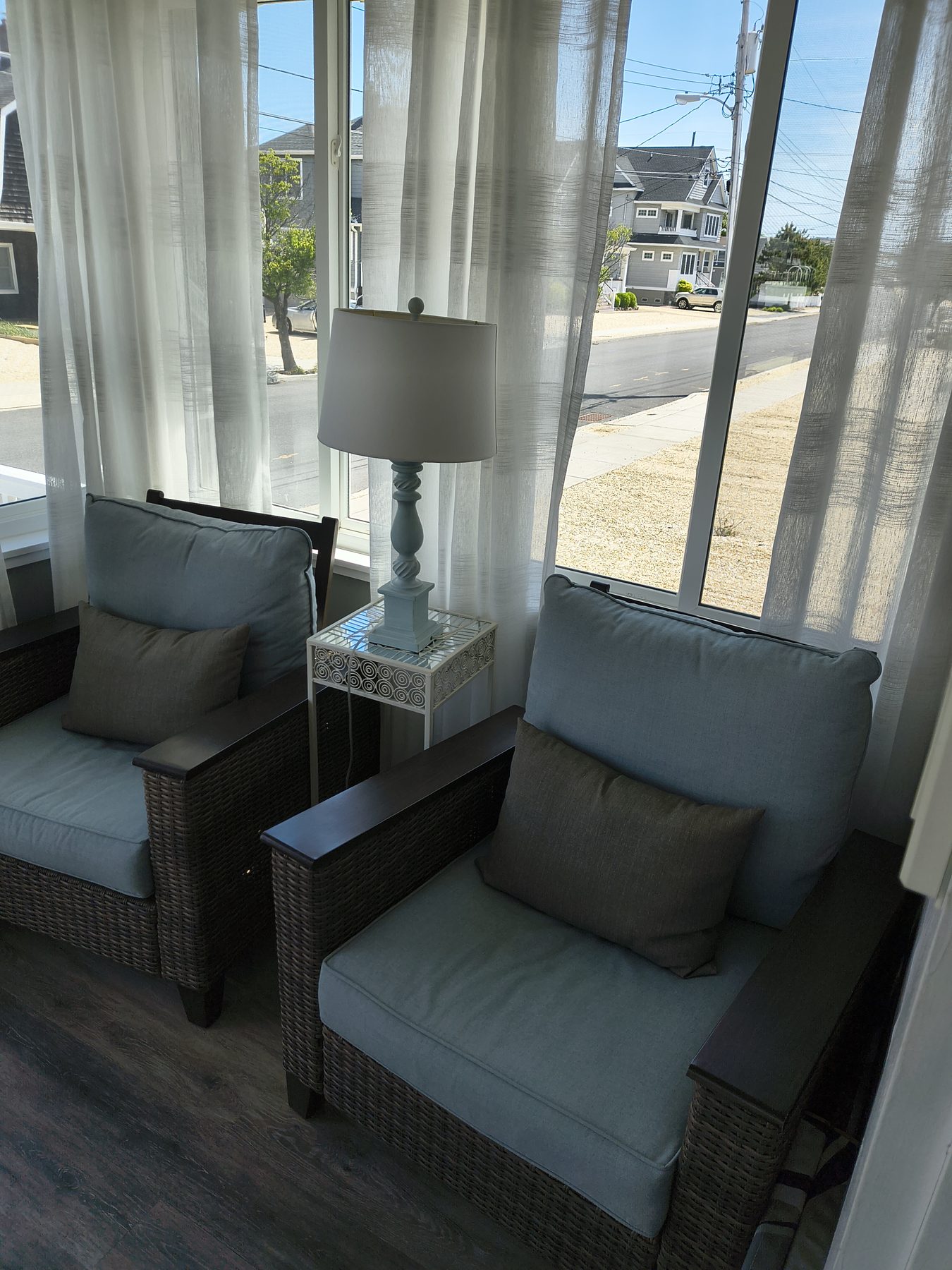 Sunroom looking out to the street through sheer curtains